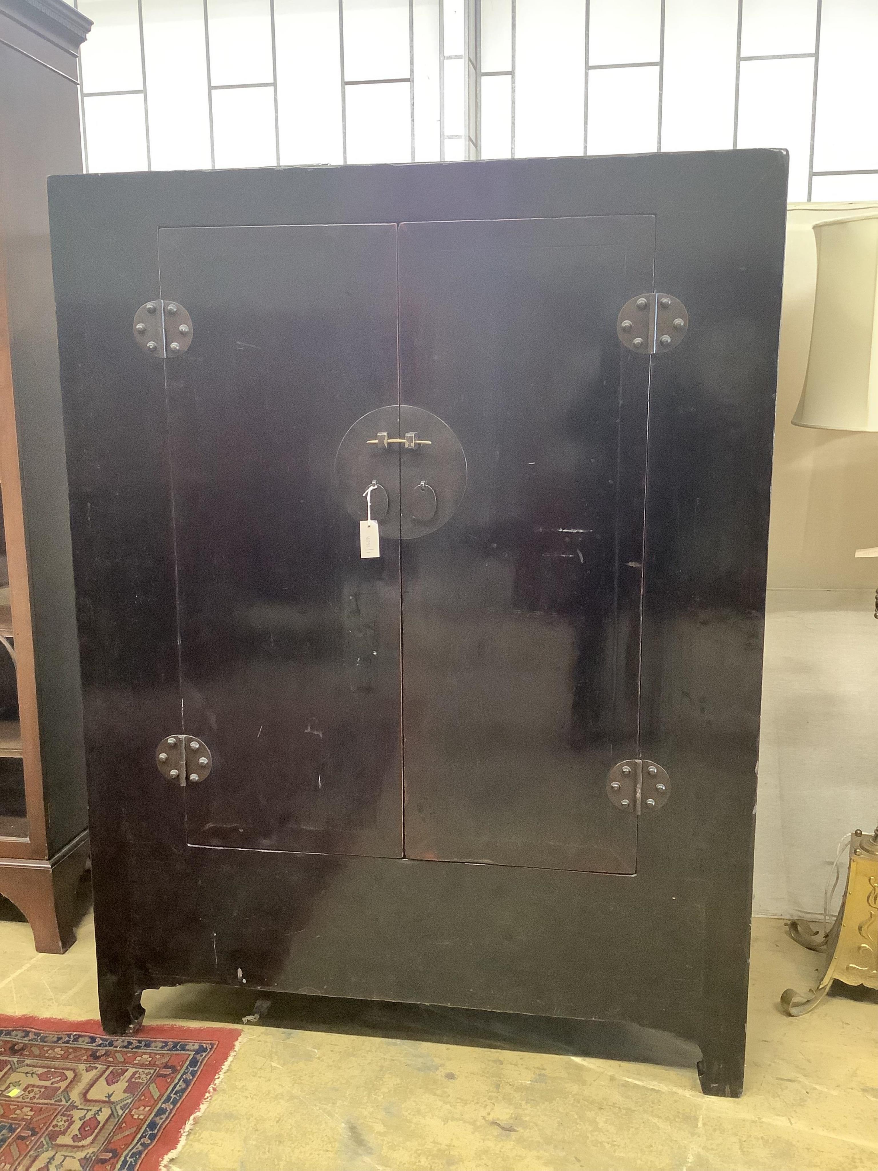 A Chinese black lacquer wardrobe, width 134cm, depth 73cm, height 177cm. Condition - fair